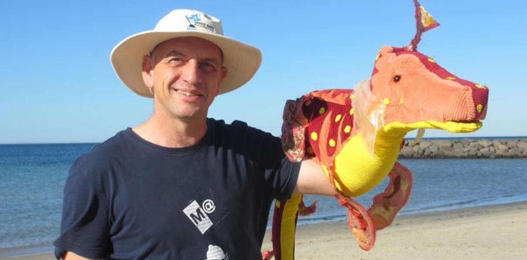 man with sea dragon puppet